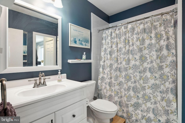 bathroom featuring vanity, toilet, and curtained shower