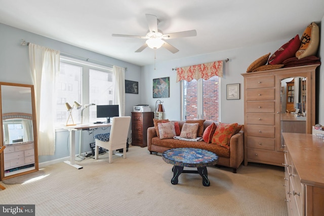 carpeted home office featuring ceiling fan and a healthy amount of sunlight