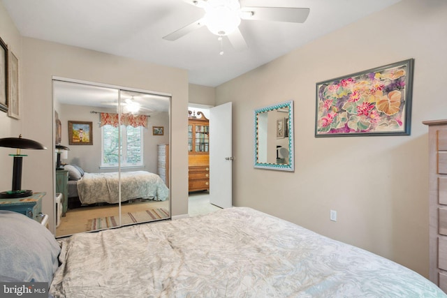 carpeted bedroom featuring a closet and ceiling fan