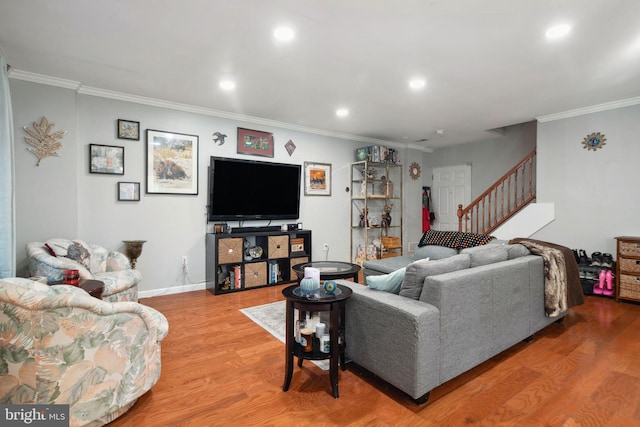 living room featuring hardwood / wood-style floors and crown molding