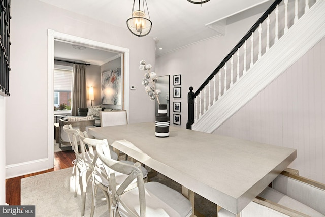 dining room featuring wood-type flooring and crown molding