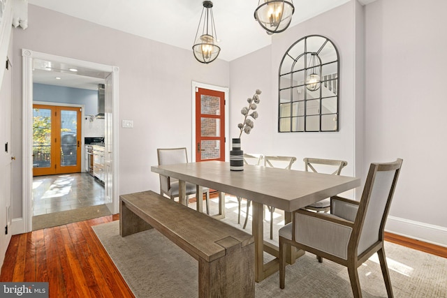 dining space featuring wood-type flooring and french doors