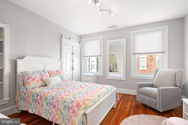 bedroom with dark hardwood / wood-style floors