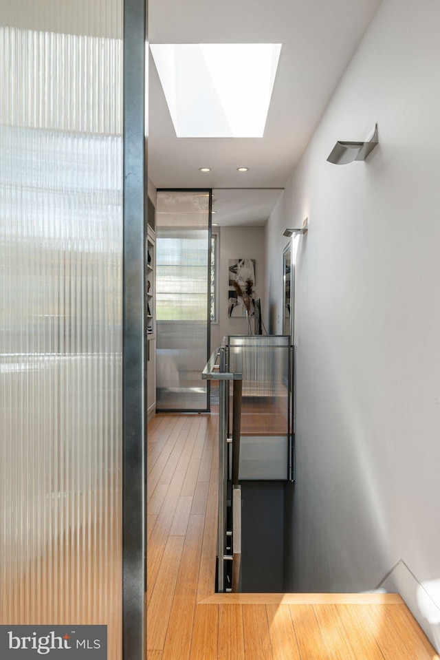 interior space featuring hardwood / wood-style floors and a skylight