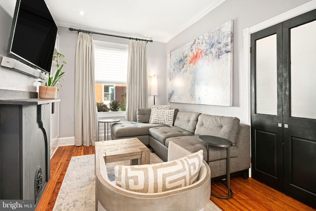 living room featuring french doors, hardwood / wood-style flooring, and ornamental molding