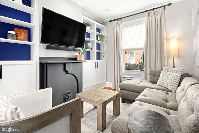 living room featuring light hardwood / wood-style floors and crown molding