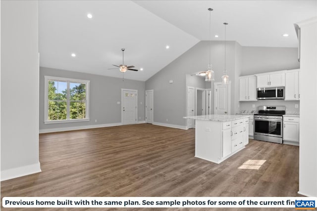 kitchen featuring a center island, white cabinets, hardwood / wood-style floors, and appliances with stainless steel finishes