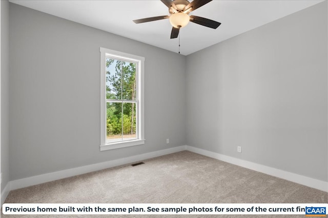 empty room featuring light colored carpet and ceiling fan