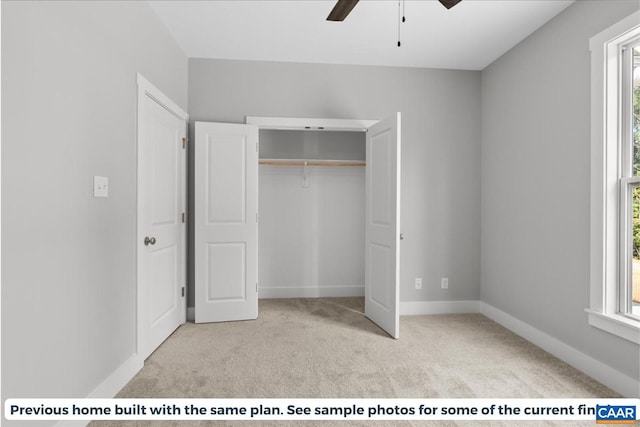 unfurnished bedroom with light carpet, a closet, multiple windows, and ceiling fan