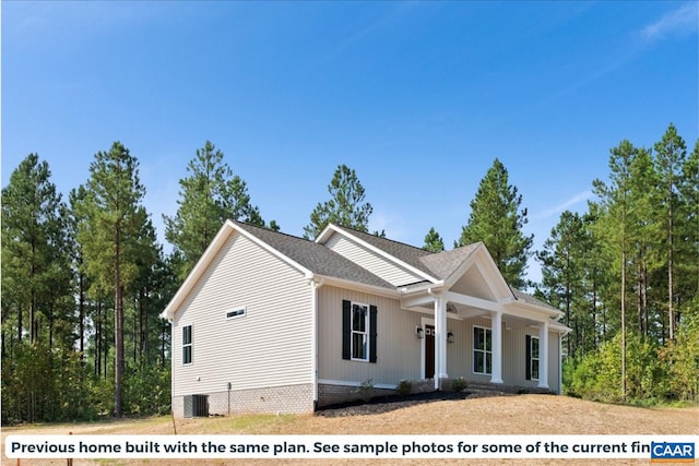 view of front of house with a porch and cooling unit