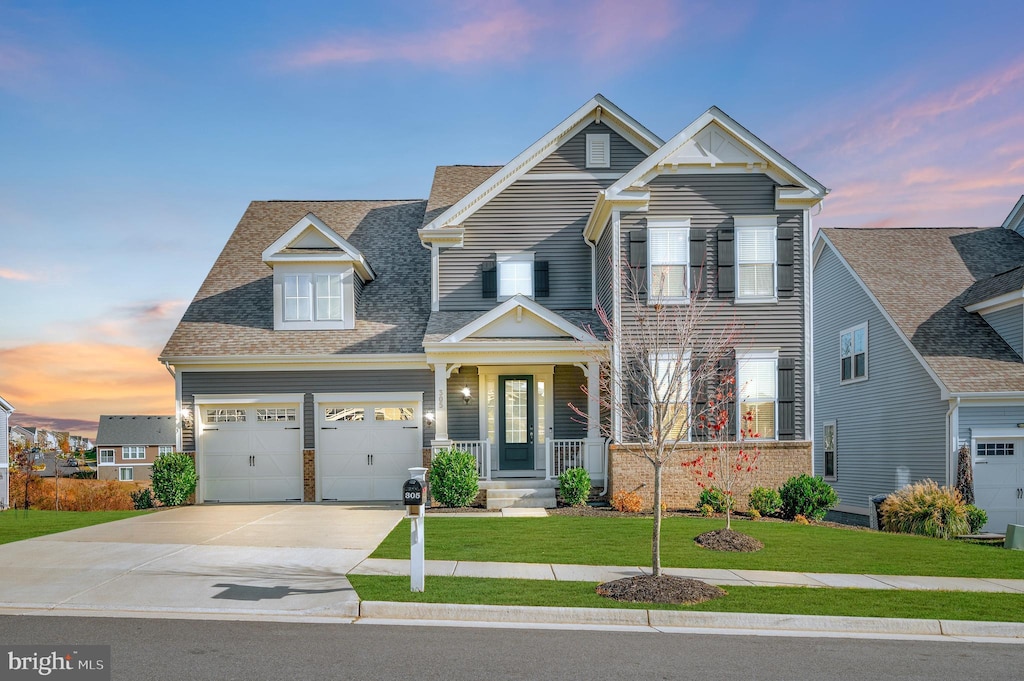 craftsman-style house with a yard and a garage