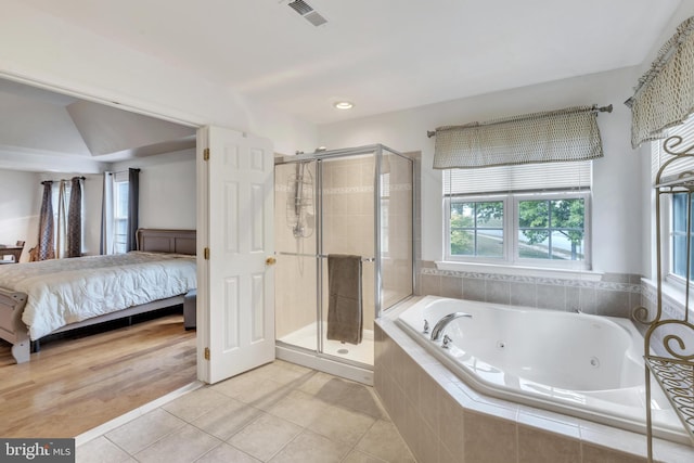 bathroom with tile patterned flooring and separate shower and tub