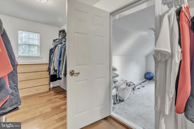 spacious closet featuring wood-type flooring and vaulted ceiling