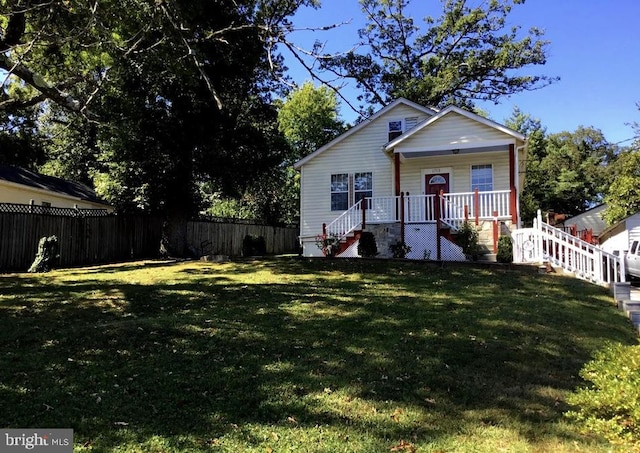 bungalow featuring covered porch and a front lawn