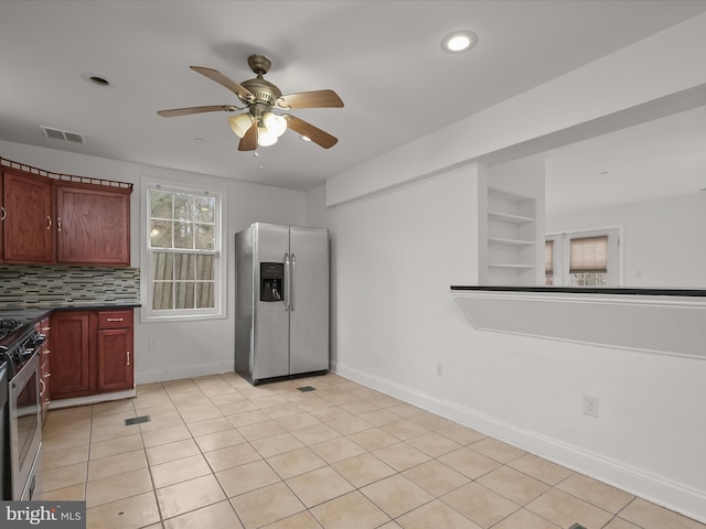 kitchen featuring tasteful backsplash, light tile patterned floors, ceiling fan, stainless steel appliances, and built in shelves