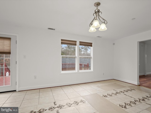 unfurnished dining area featuring light tile patterned floors and a chandelier