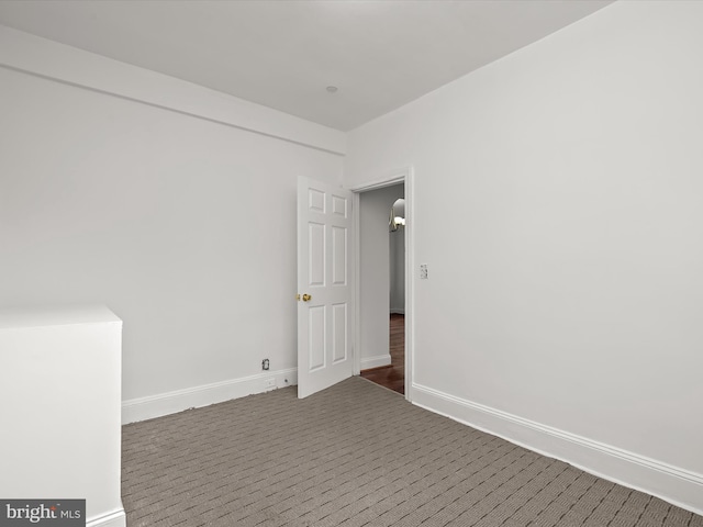 empty room with dark carpet