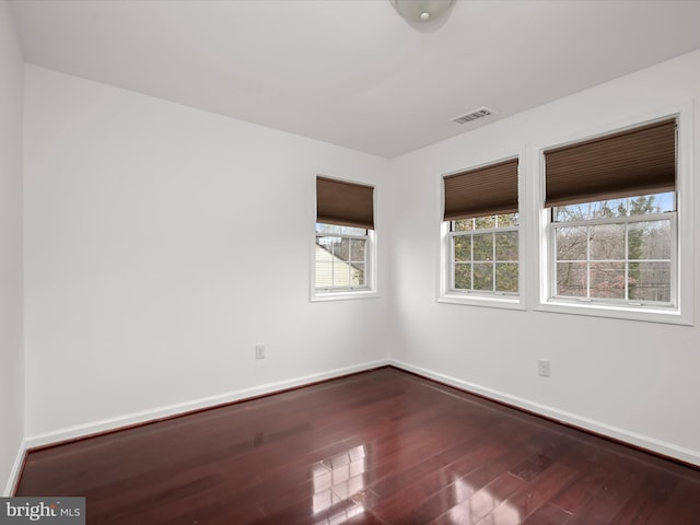 spare room with hardwood / wood-style flooring