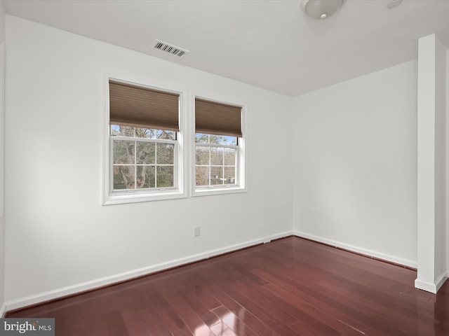 spare room featuring dark hardwood / wood-style floors