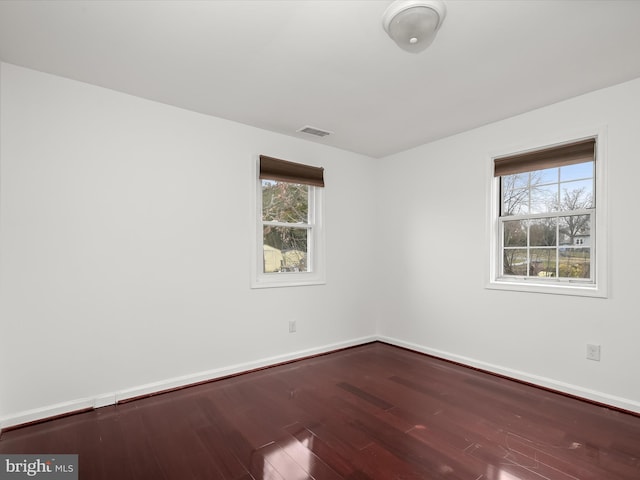 unfurnished room featuring hardwood / wood-style flooring and a wealth of natural light