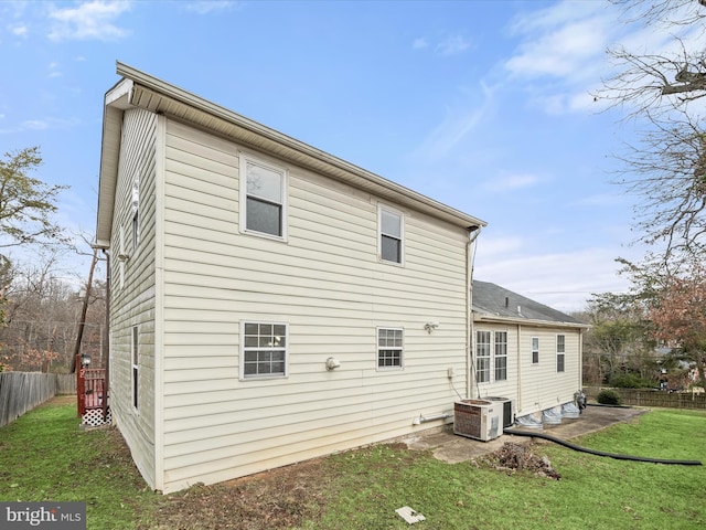 rear view of property featuring a lawn