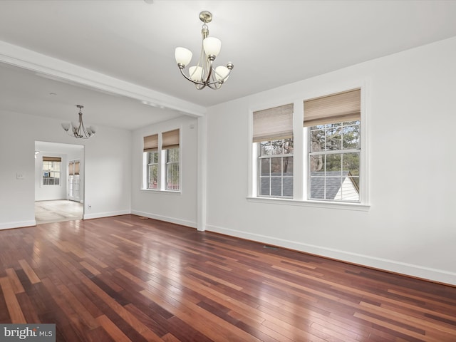 interior space featuring dark wood-type flooring and an inviting chandelier