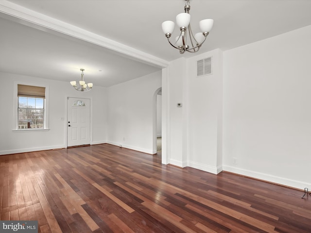 interior space with dark hardwood / wood-style flooring and a notable chandelier