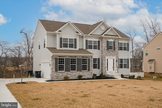 view of front facade with a garage and a front lawn