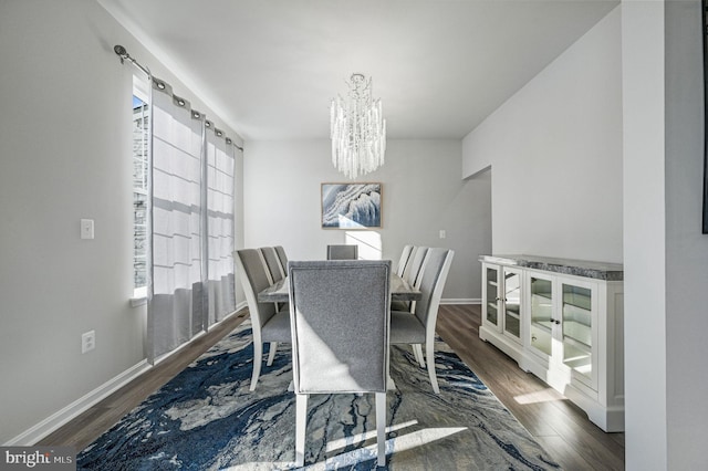 dining area featuring an inviting chandelier and dark hardwood / wood-style flooring