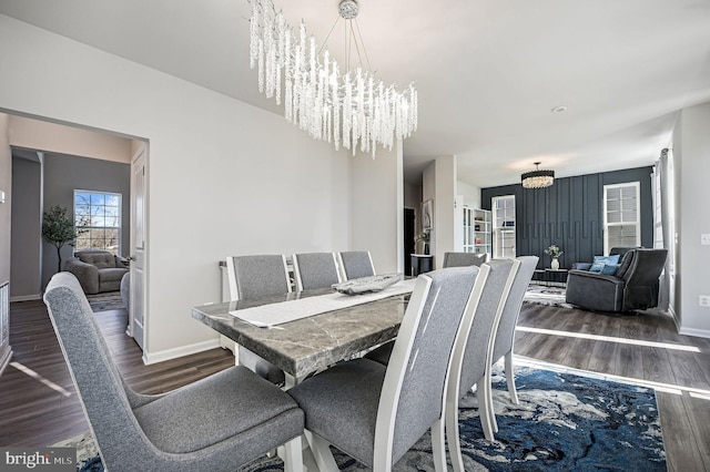 dining space featuring an inviting chandelier and dark wood-type flooring