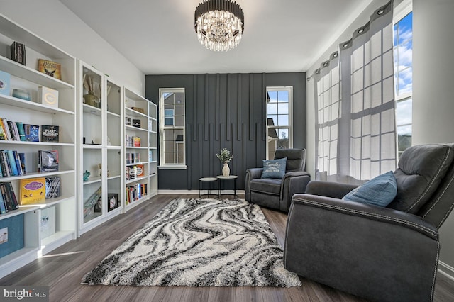 sitting room featuring dark hardwood / wood-style flooring and a notable chandelier