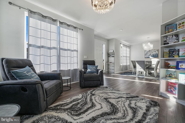 sitting room featuring an inviting chandelier and dark hardwood / wood-style flooring