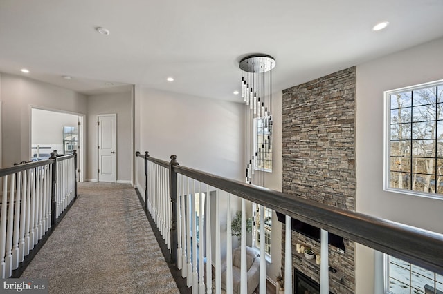 hall featuring dark colored carpet