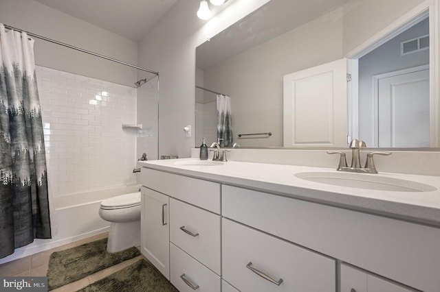 full bathroom with shower / bathtub combination with curtain, vanity, tile patterned flooring, and toilet