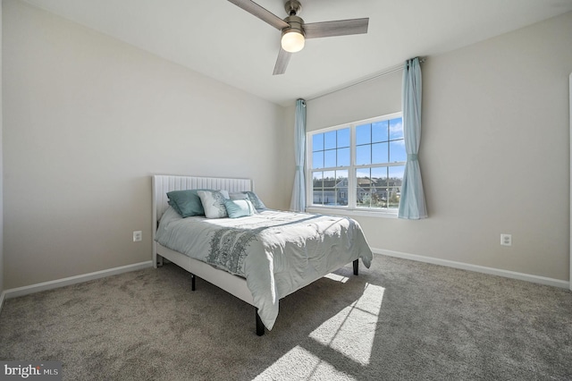 bedroom with ceiling fan and dark colored carpet