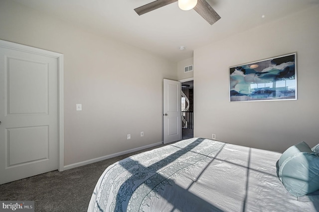 bedroom with ceiling fan and dark carpet