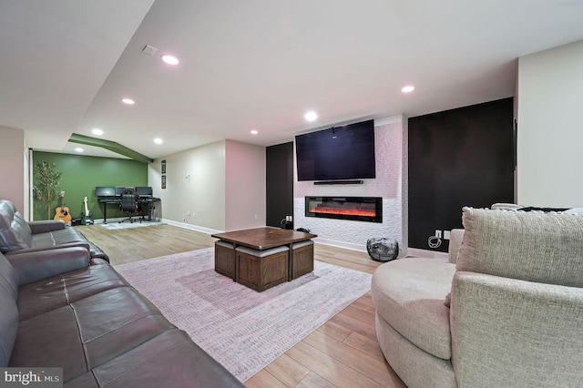 living room with a fireplace and light hardwood / wood-style flooring