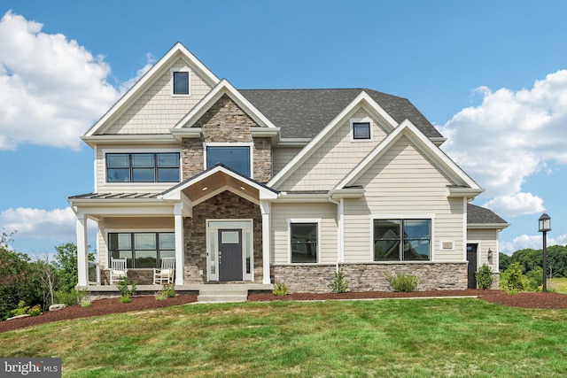 craftsman-style home featuring a front yard and covered porch