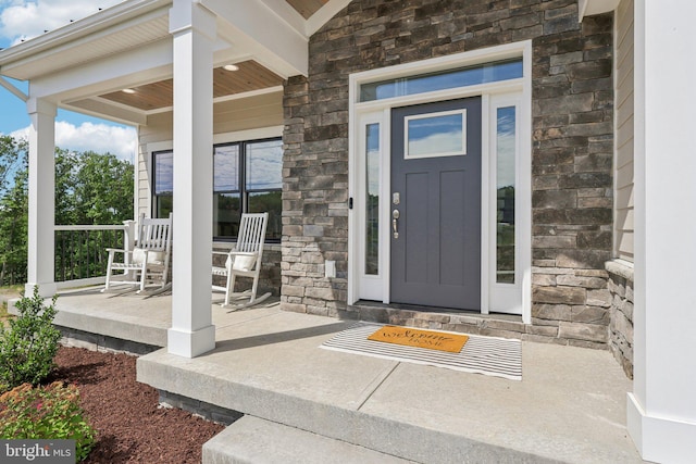 view of exterior entry with a porch