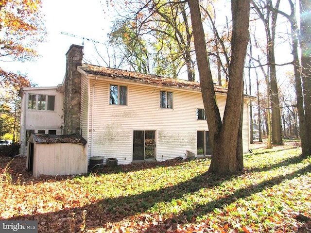 view of home's exterior featuring central air condition unit and a yard