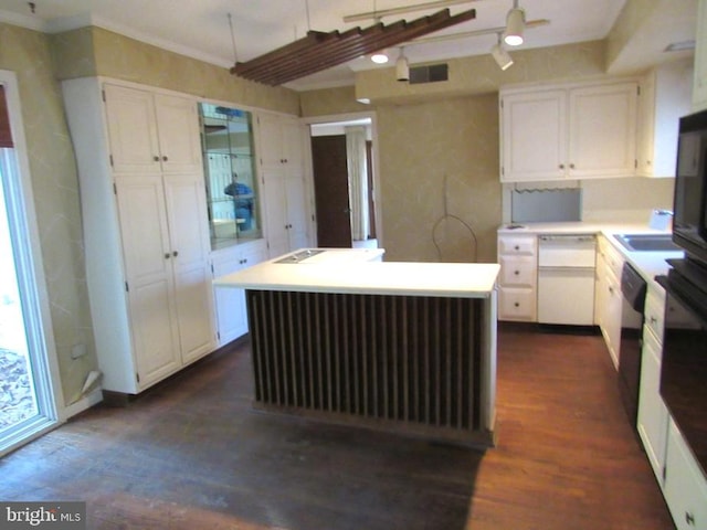 kitchen with dishwasher, dark wood-type flooring, white cabinets, sink, and a kitchen island