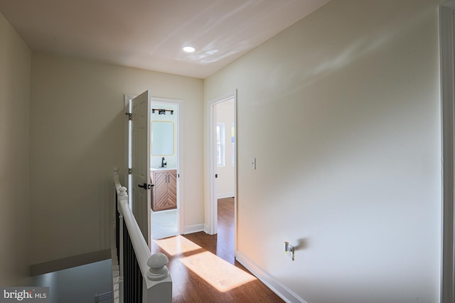 hallway with sink and hardwood / wood-style floors