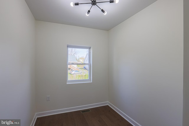 spare room featuring dark hardwood / wood-style floors