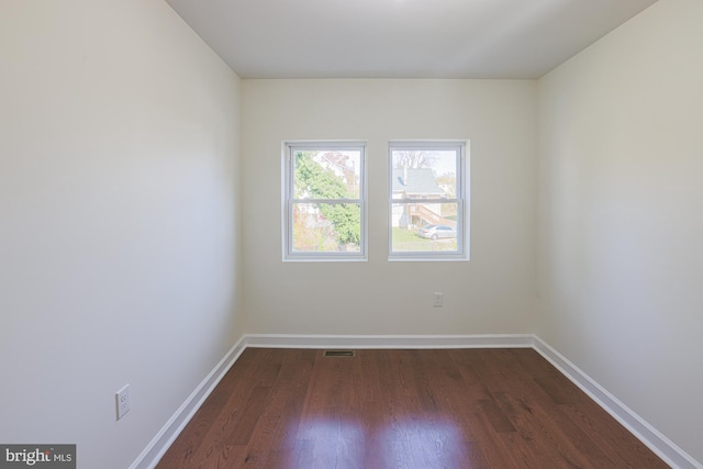 unfurnished room featuring dark wood-type flooring