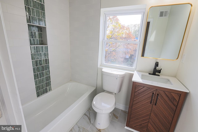 full bathroom with vanity, tiled shower / bath, and toilet