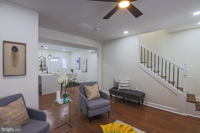 sitting room with dark wood-type flooring, sink, and ceiling fan