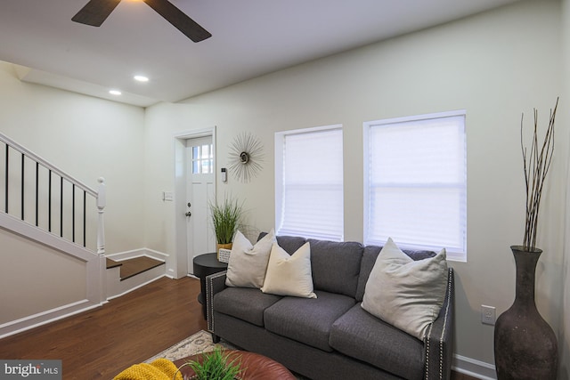 living room featuring a wealth of natural light, dark hardwood / wood-style floors, and ceiling fan