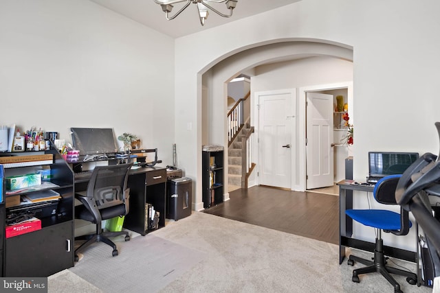 office area with hardwood / wood-style floors and an inviting chandelier