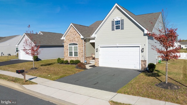 view of front of home with a garage and a front lawn