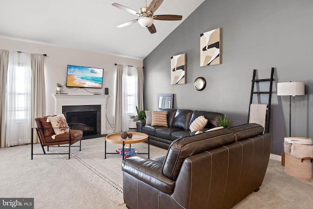 carpeted living room with ceiling fan and high vaulted ceiling